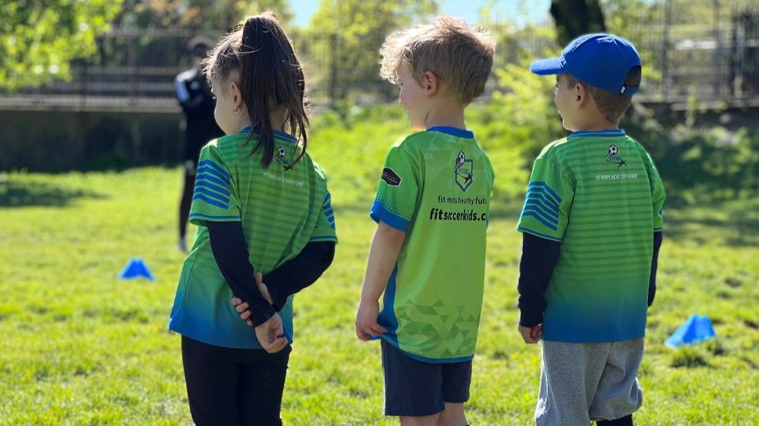 Fit Soccer Kids coaches and players sharing an active class moment