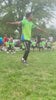 Fit Soccer Kids coach running alongside young players during an outdoor soccer class 